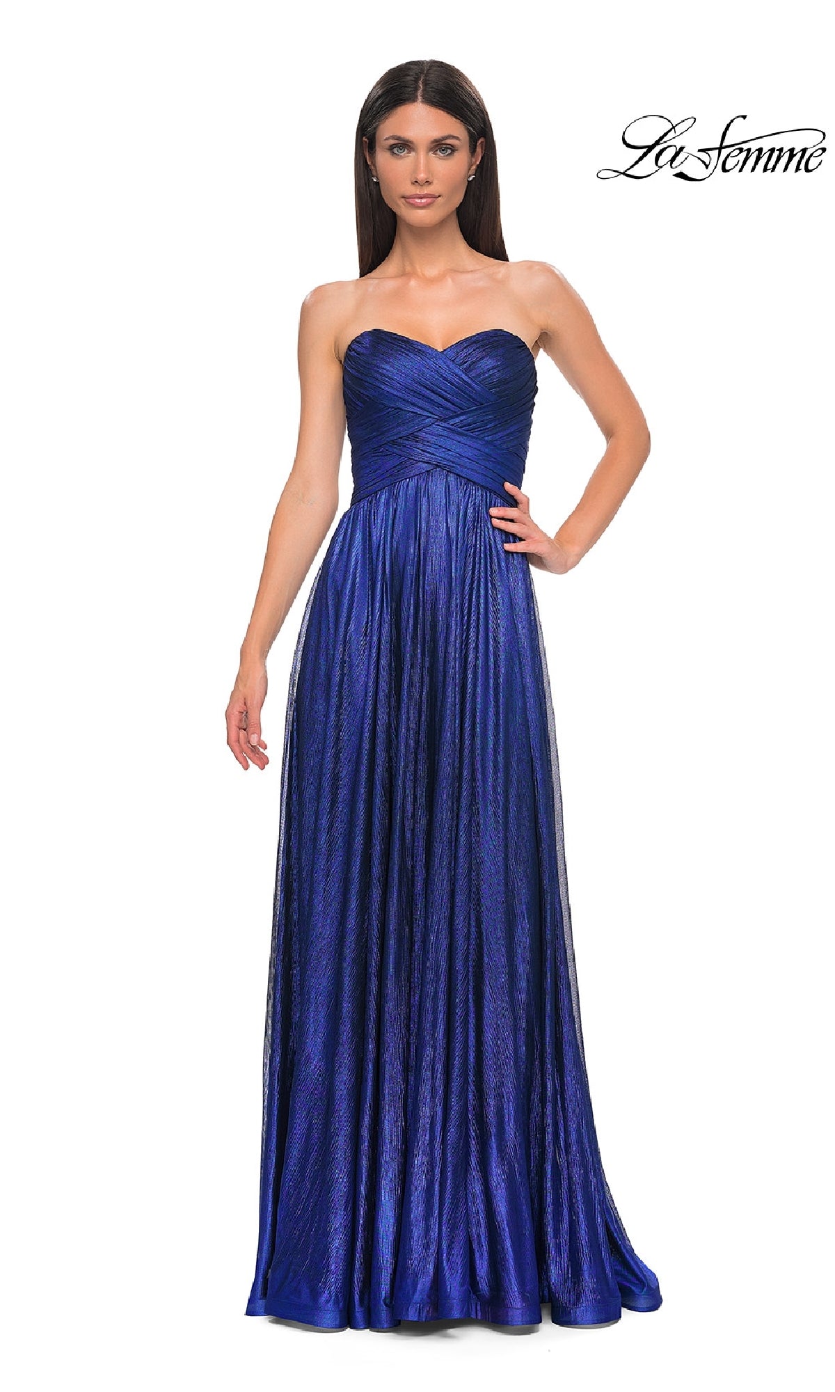 A woman models the Strapless Long Metallic Prom Dress, La Femme 32382—a floor-length, royal blue gown with a pleated bodice—standing against a white background. The La Femme logo is displayed in the top right corner.